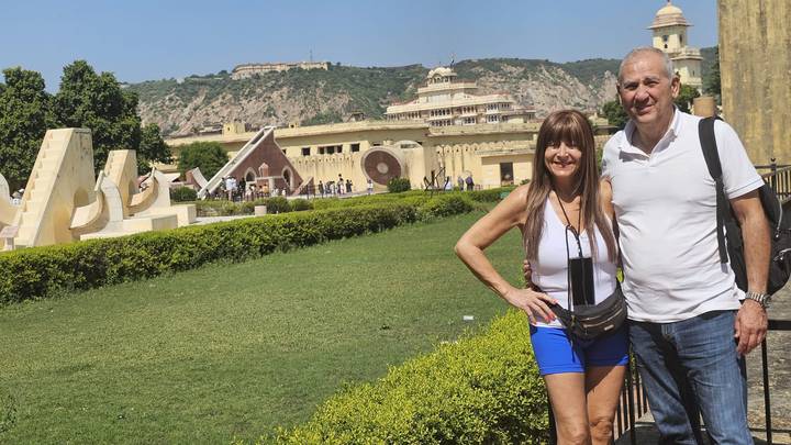Couple posing with historical buildings in the background.