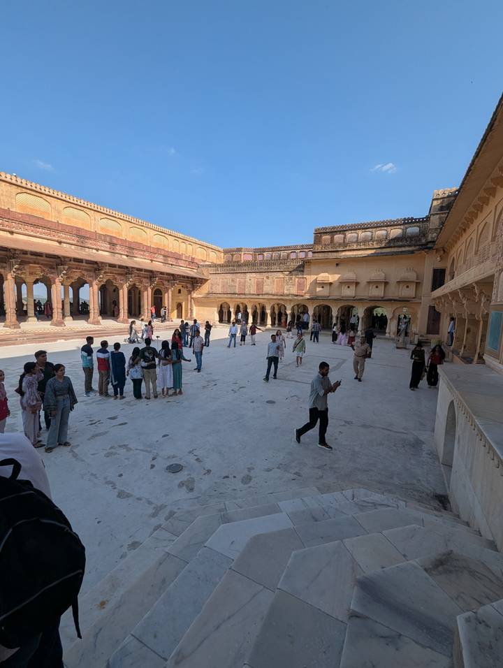 People gathered in a historic courtyard.