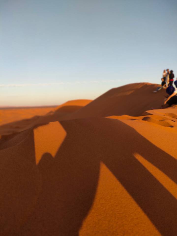 Dunes de sable floues avec des ombres au coucher du soleil.