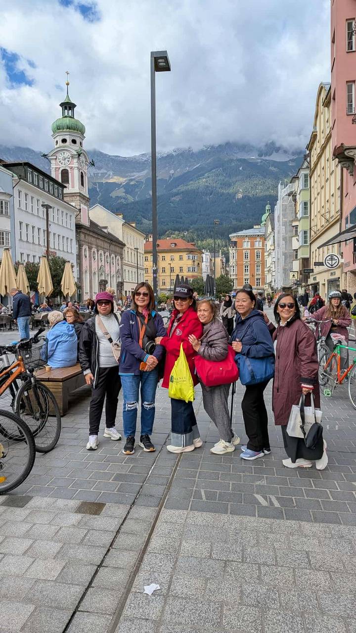 Groupe de femmes dans une rue européenne animée avec des vélos.