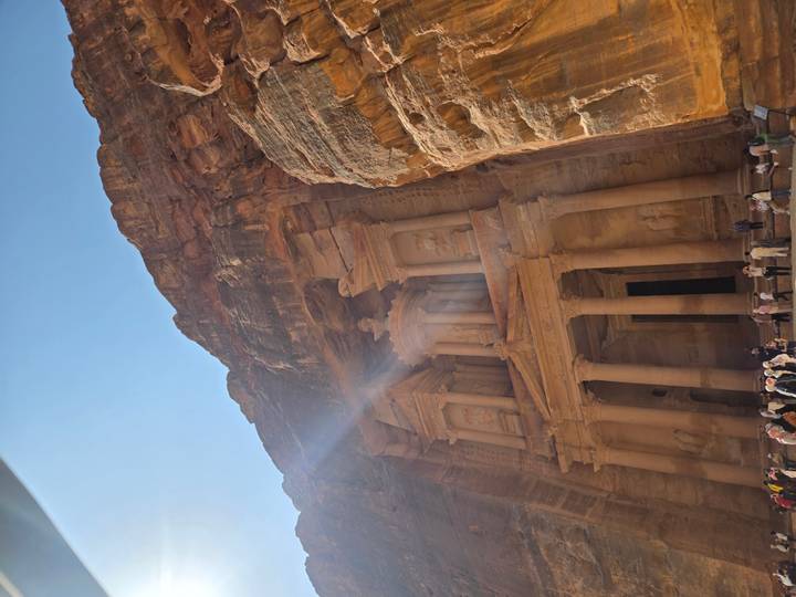 The Treasury in Petra with tourists gathered at the site.
