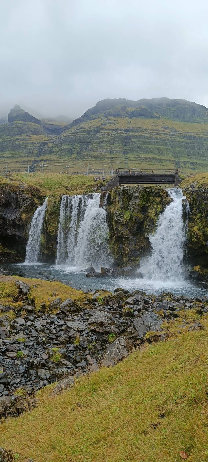 Waterfall with mossy rocks and flowing water.