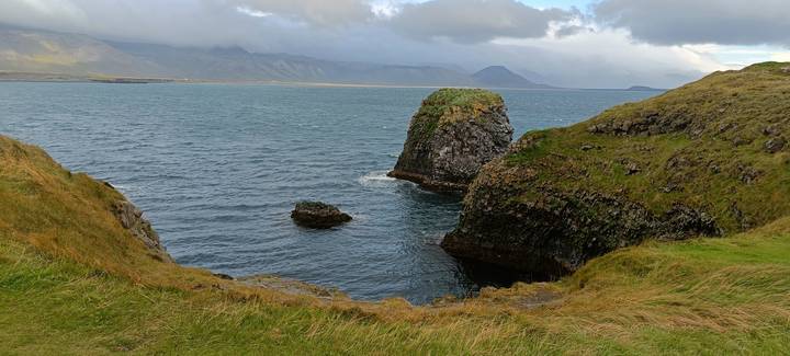 Coastal landscape with rocky cliffs and the ocean.