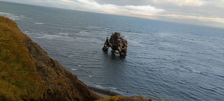 Rock formation in the sea with waves and cliffs.