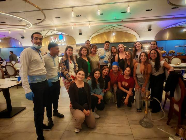 A group of people indoors, likely in a restaurant setting.