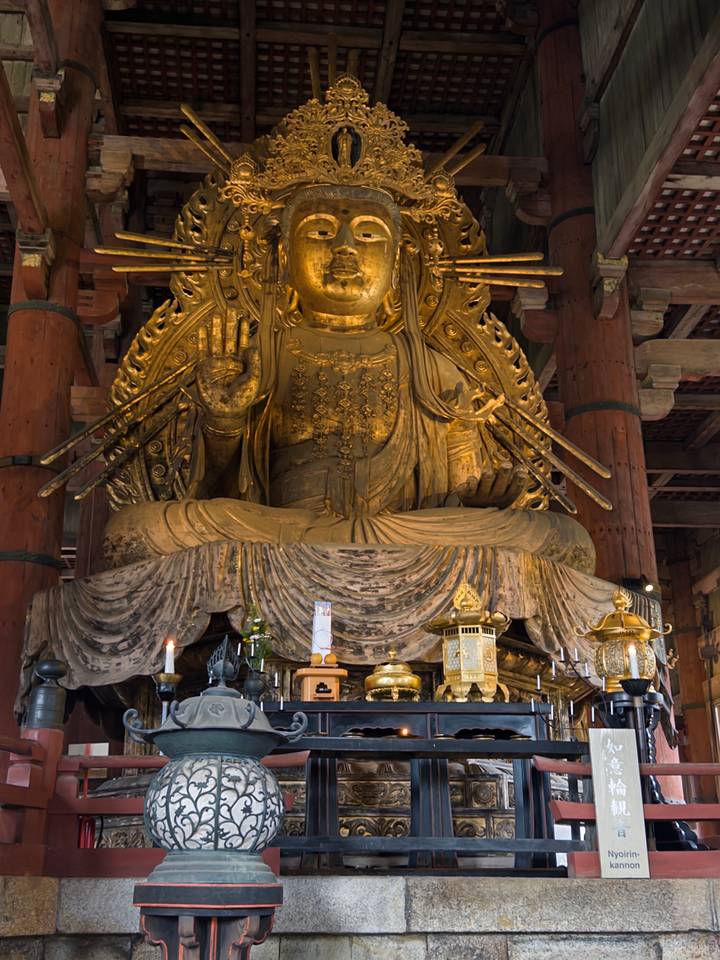 Gilded statue inside a temple.