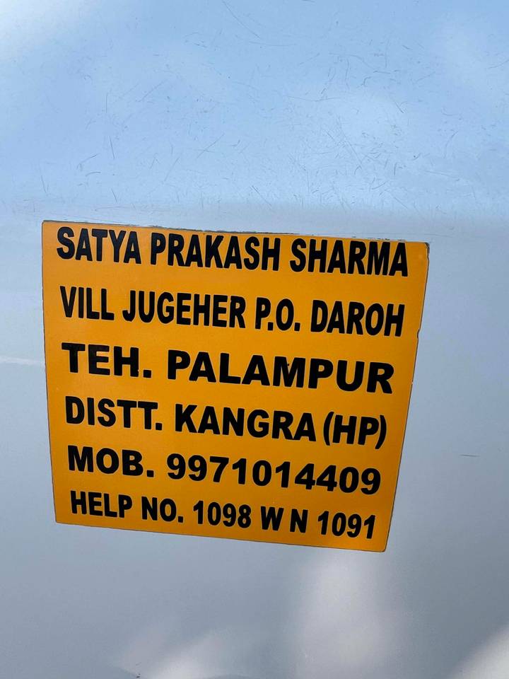 Close-up of a sign with contact information and address.