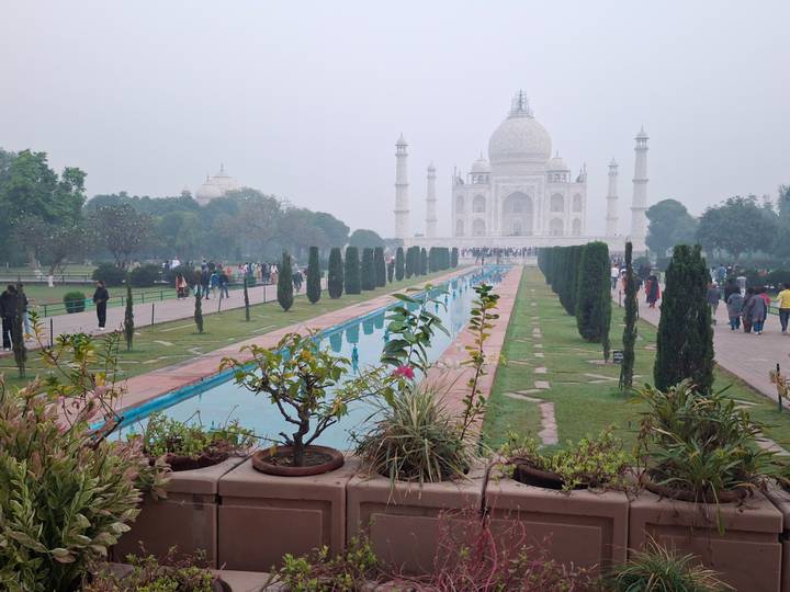 View of the Taj Mahal with gardens and reflection pool.