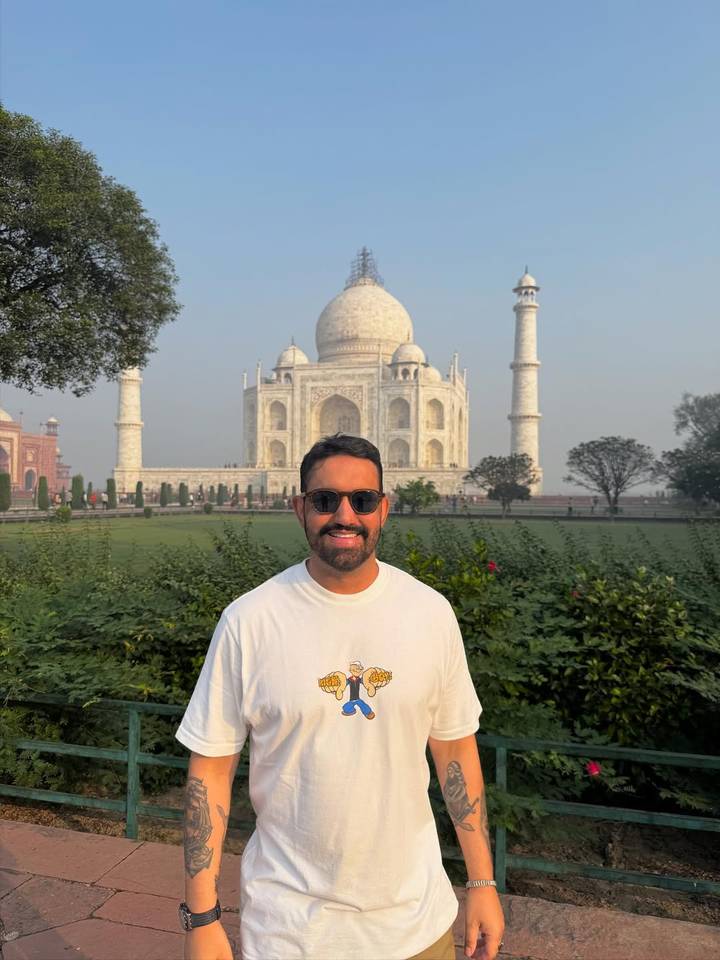 A man in front of the Taj Mahal.