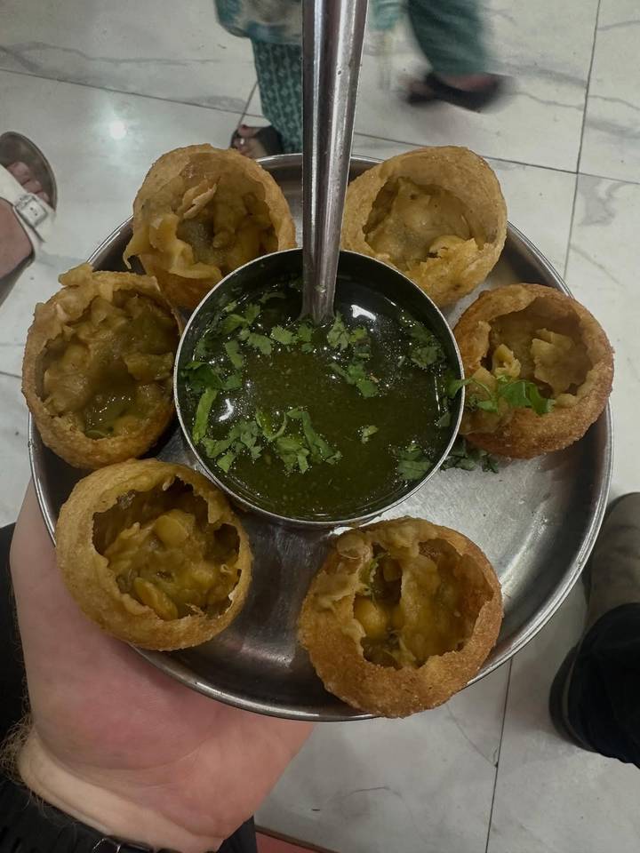 Indian street food with spicy water and crispy puris.