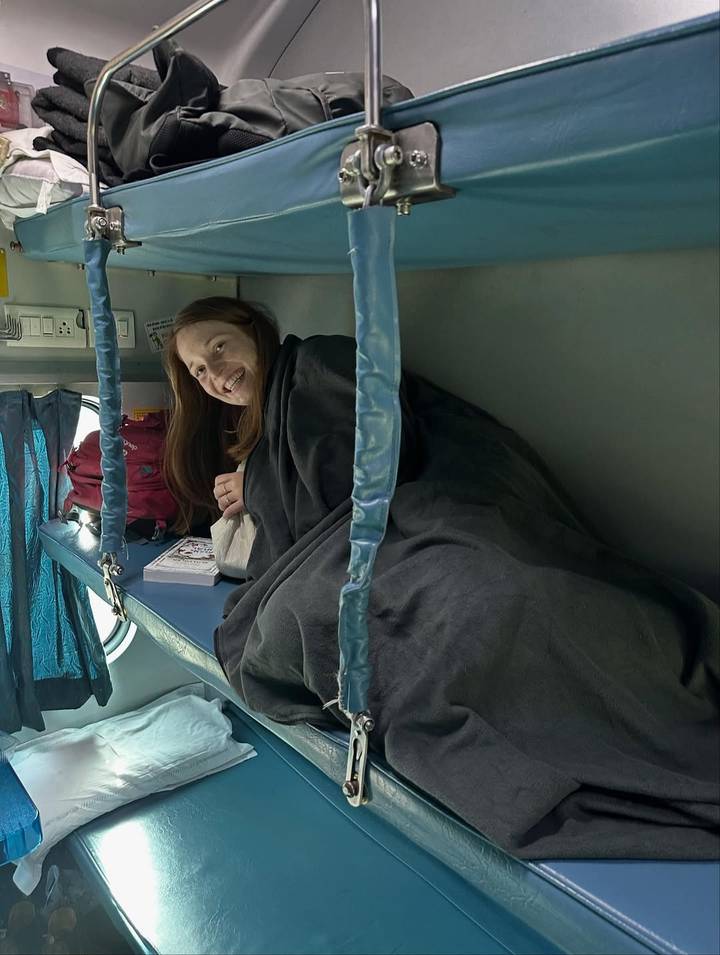 Person in a bunk on a train in India.