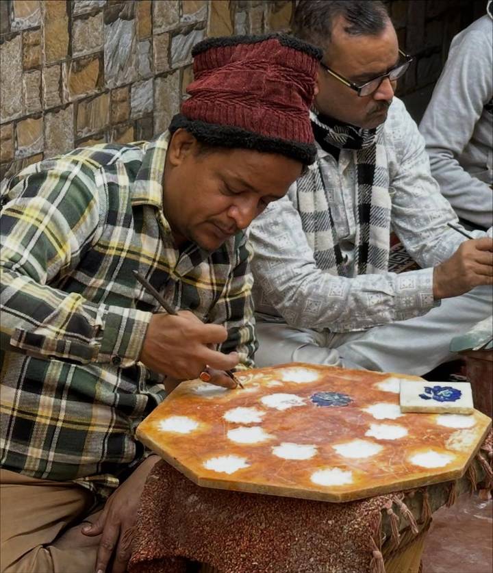 Artist working on an intricate artwork.