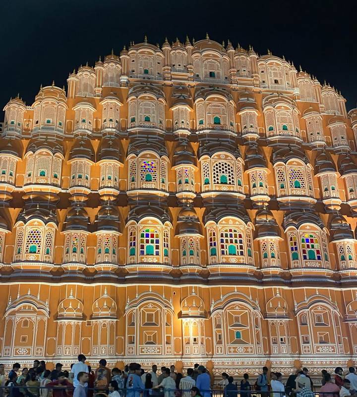 A beautifully lit building with intricate architecture and colorful windows.