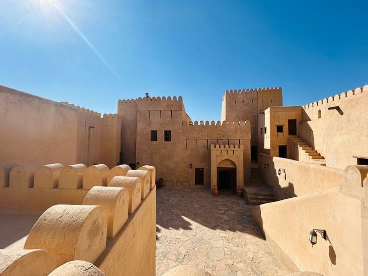 Historic fort with sand-colored walls under clear blue sky.