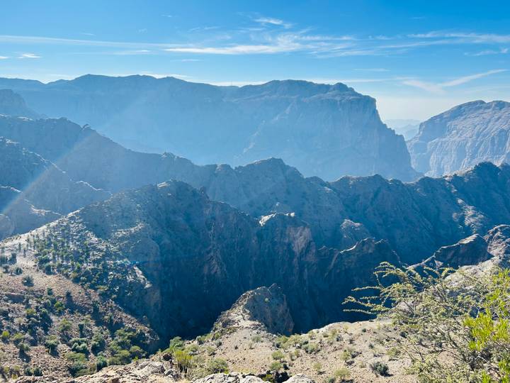 A majestic mountain landscape with clear skies and rugged terrain.