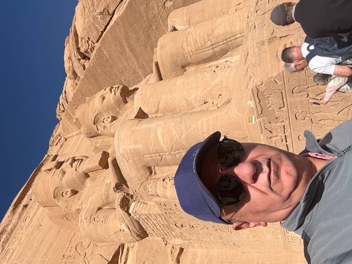 Tourist taking a selfie in front of the Abu Simbel temple.