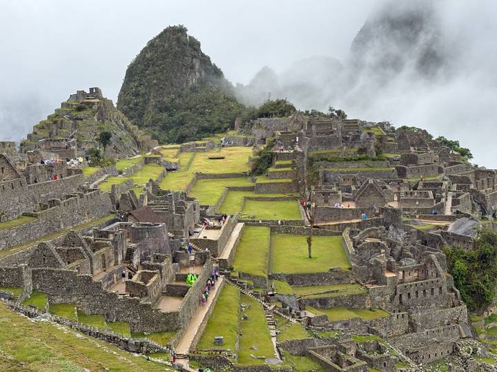 Ruins of Machu Picchu with terraces and architectural structures.