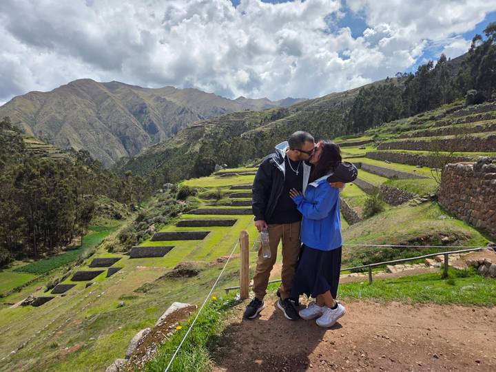 Couple embracing with terraced hills in the background.