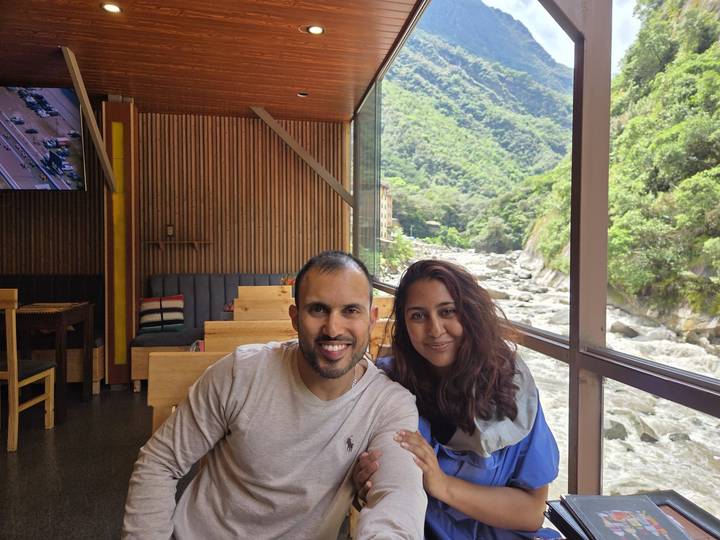 Couple in a restaurant with a river view outside.