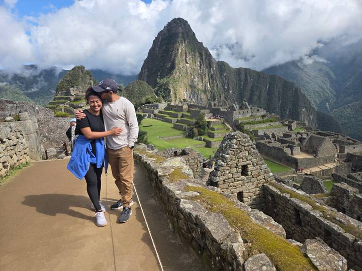 Couple posing with Machu Picchu in the background.