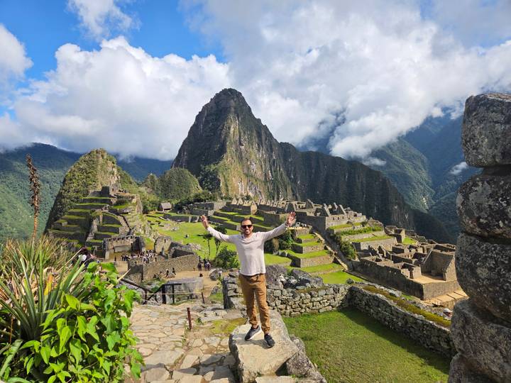 Person celebrating in front of Machu Picchu.