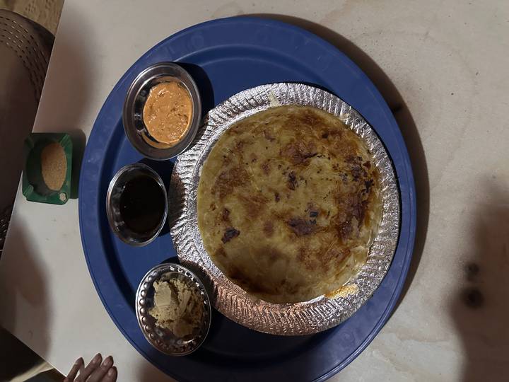 A plate of traditional food with three sauces.
