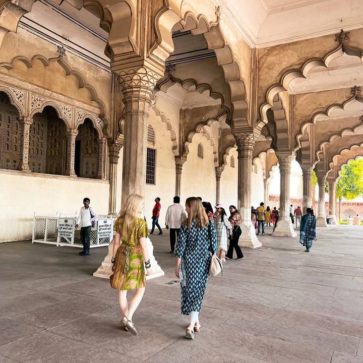 Des visiteurs marchant à travers les arches majestueuses d'un site historique.