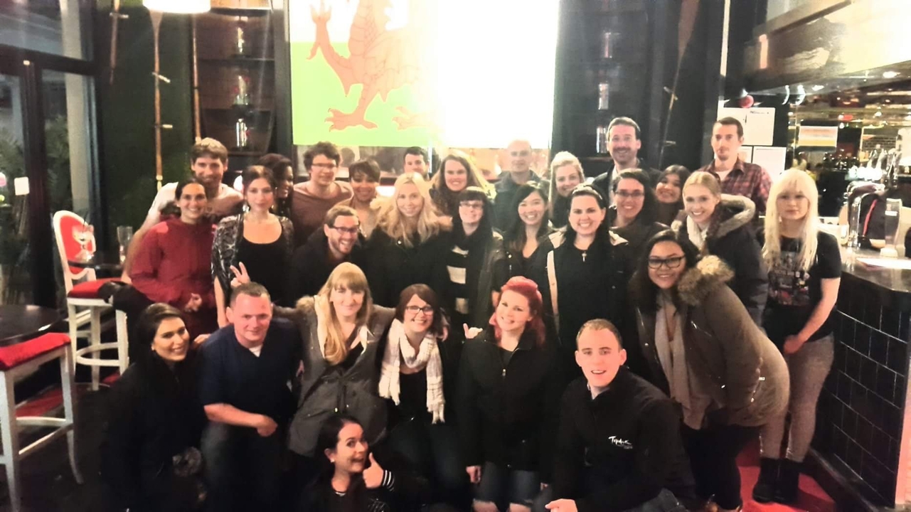 Groupe de personnes posant à l'intérieur lors d'un événement.