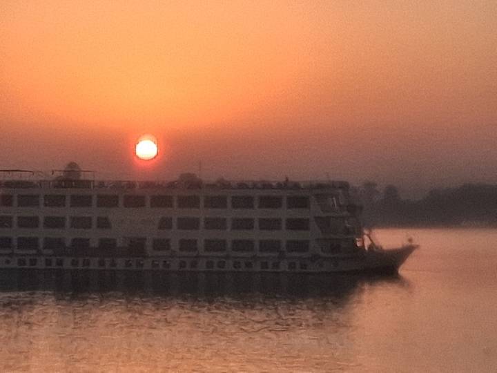 Sunset with a silhouetted riverboat.