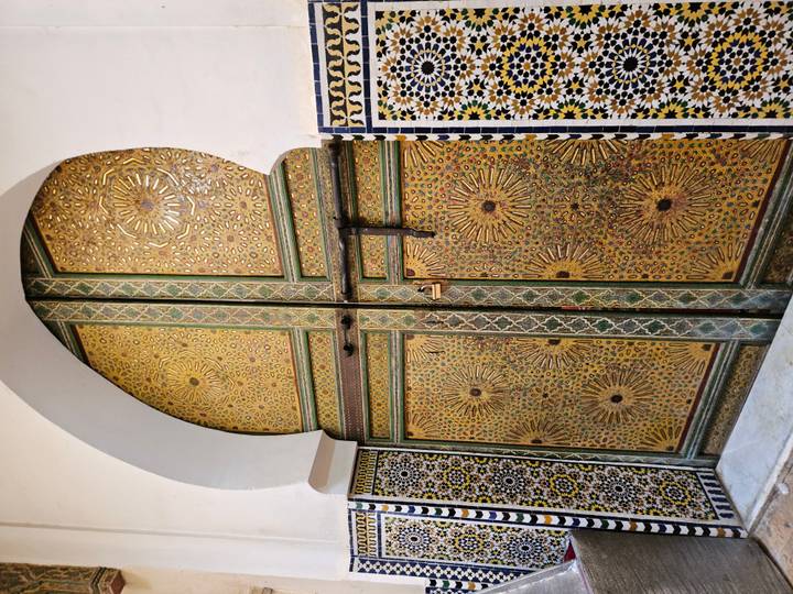 Ornate golden door with intricate designs.