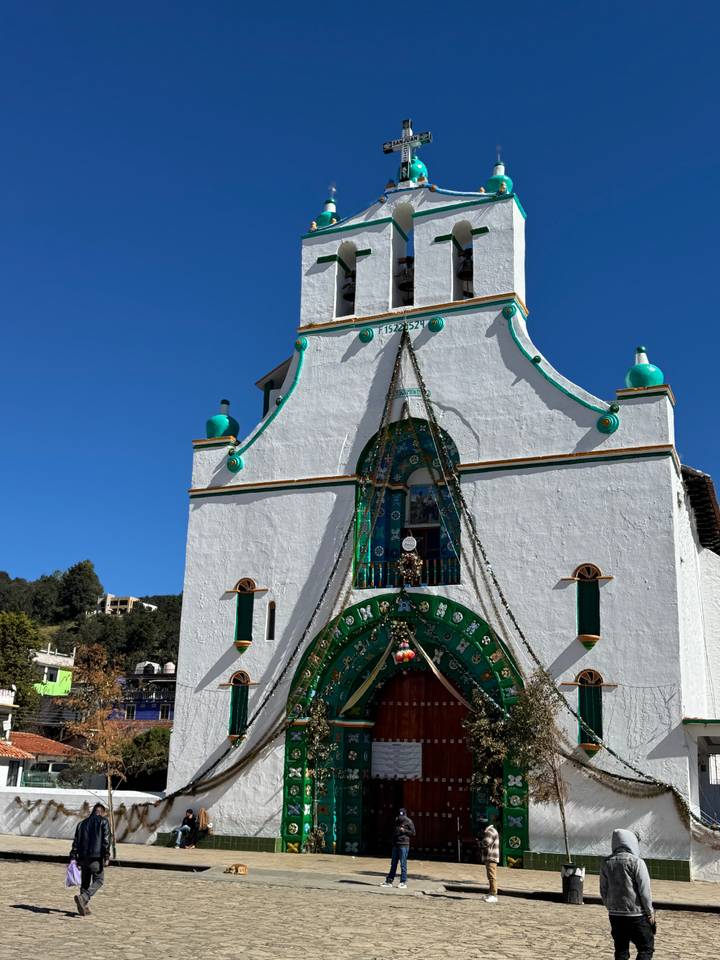 White church with intricate designs and a clear blue sky.
