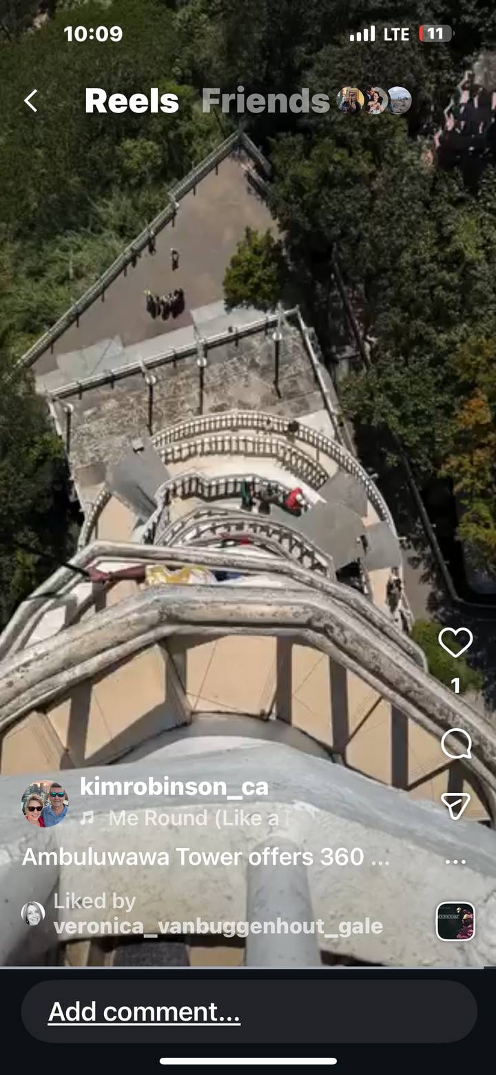 An overhead view of an ornate staircase with people on different levels.
