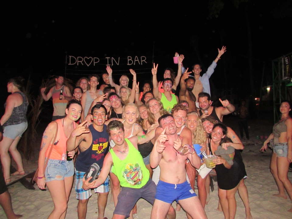 Group of people at a night beach party.