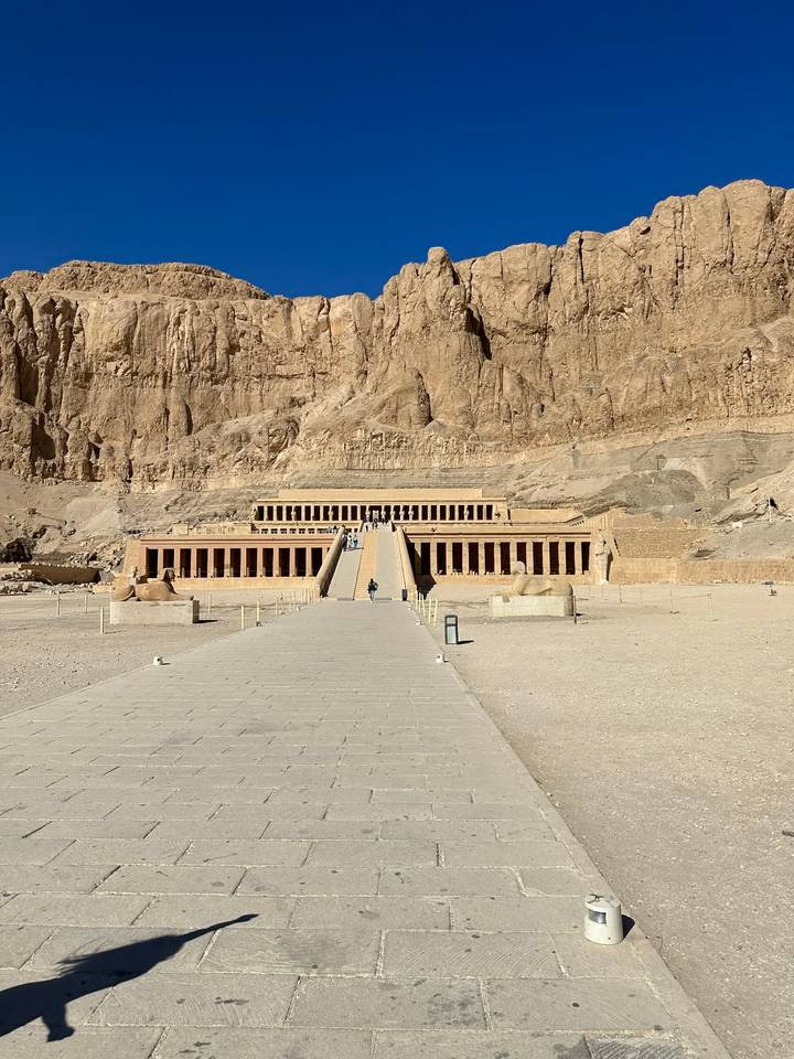 Wide view of the terraced Mortuary Temple of Hatshepsut against a rocky cliff