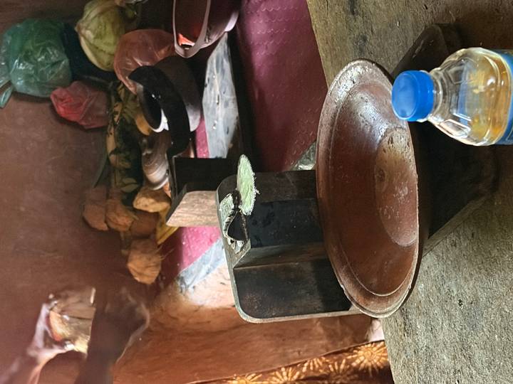 Rustic market interior featuring a traditional balance scale, clay bowl and a plastic water bottle.