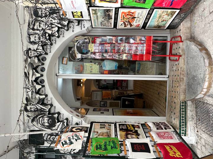 Eclectic storefront in Tangier decorated with black-and-white murals and postcards