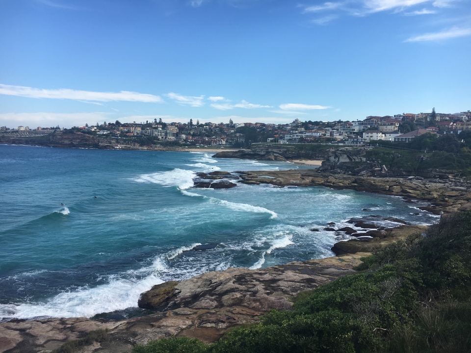 Coastal view with rocky cliffs and waves in Bondi Beach, Sydney.
