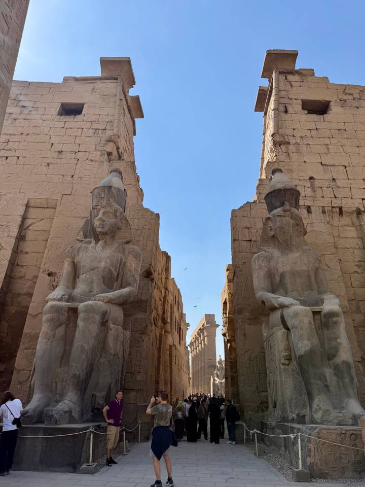 Stone pharaoh statues facing each other inside Karnak Temple.