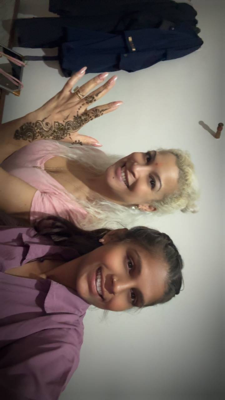 Woman and young girl smiling together for a selfie indoors