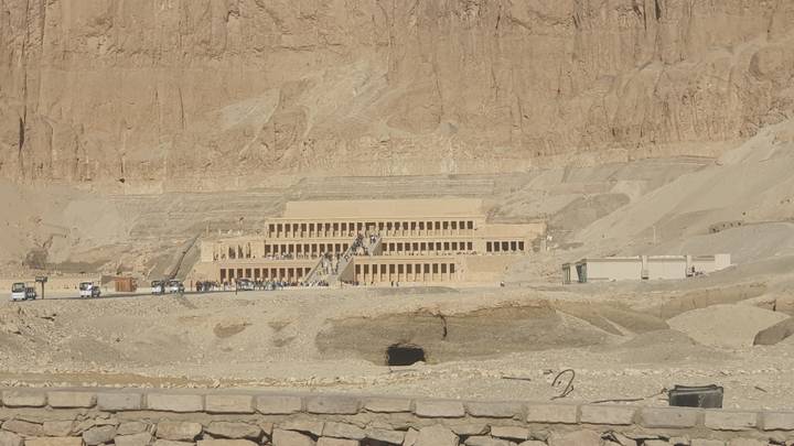Terraced mortuary temple set against sheer desert cliffs in Luxor.