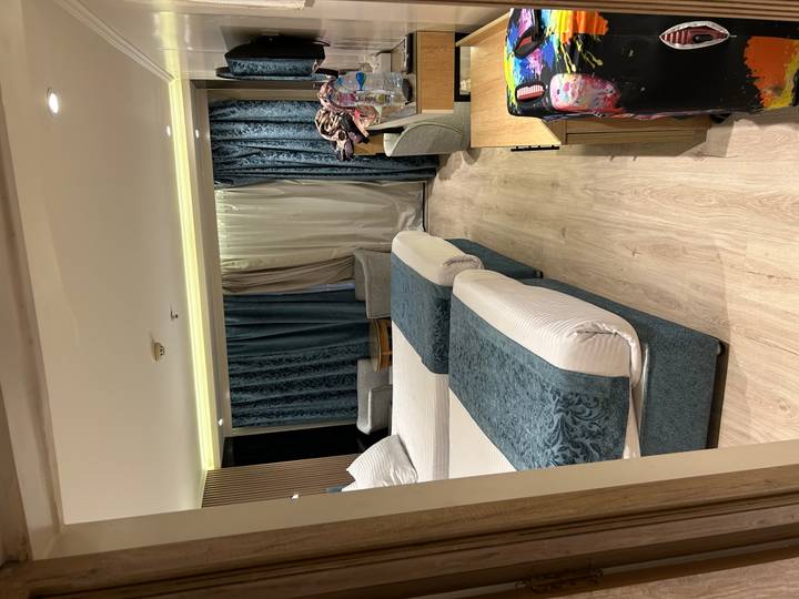 Modern twin-bed cabin with teal accents aboard Nile cruise vessel.
