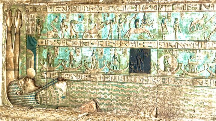 Turquoise-toned relief depicting boats and celestial motifs, likely on temple ceiling panel.