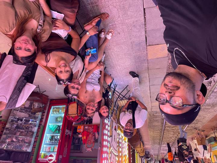 Friends relax at a café along Hanoi’s famous Train Street with railway tracks at their feet.