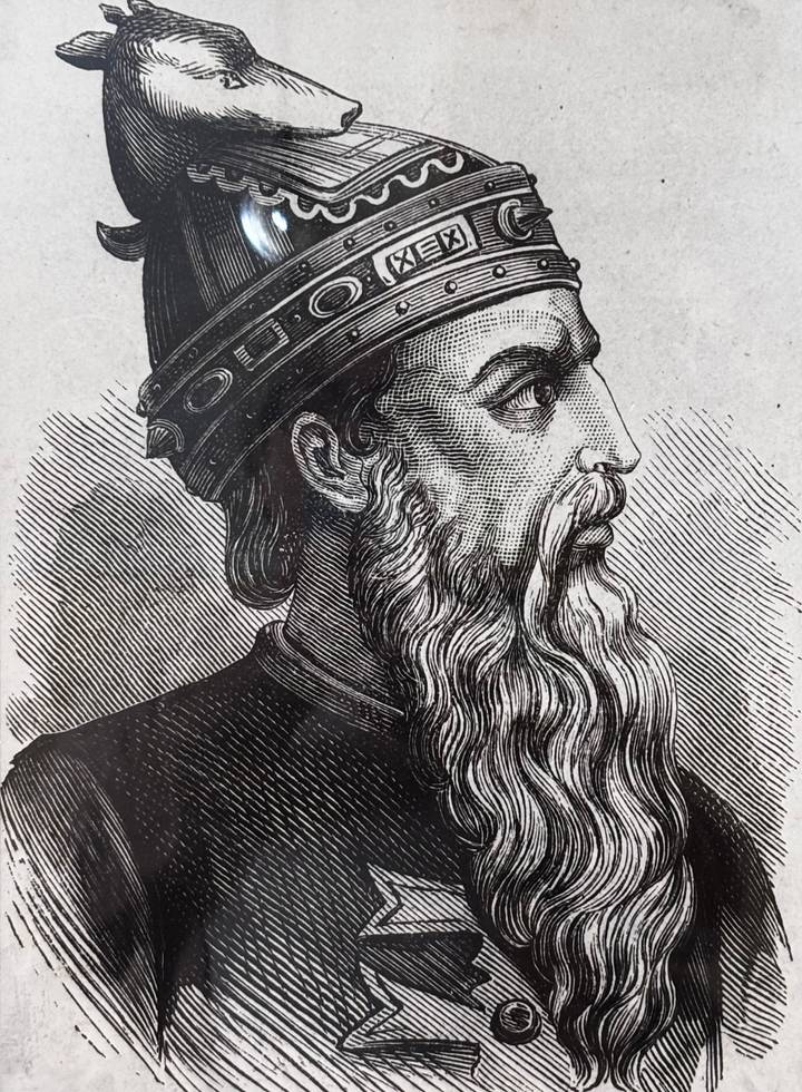 Detailed black-and-white engraving of a bearded historical figure wearing a decorated cap, photographed up-close.