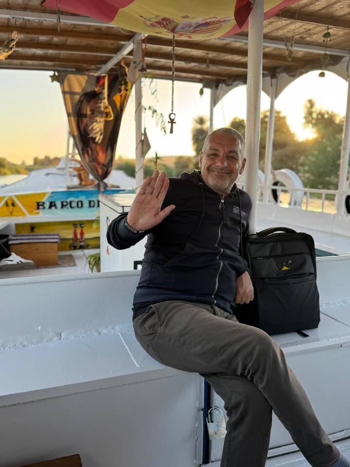 Friendly boat crew member smiling and waving on deck