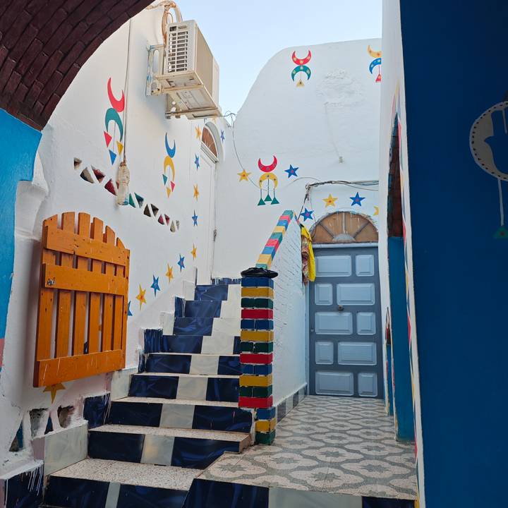 Brightly painted Nubian staircase with colourful stars, crescents and geometric patterns in Aswan village.