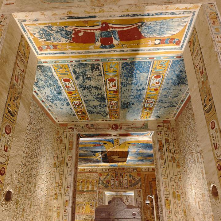 Finely preserved painted ceilings and hieroglyphic reliefs inside an ancient Egyptian tomb.