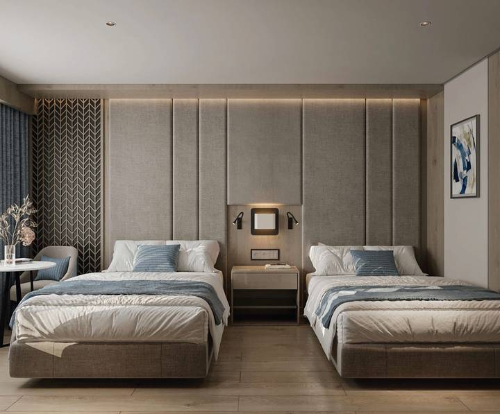 Contemporary hotel room with two neatly made beds and minimalist neutral décor