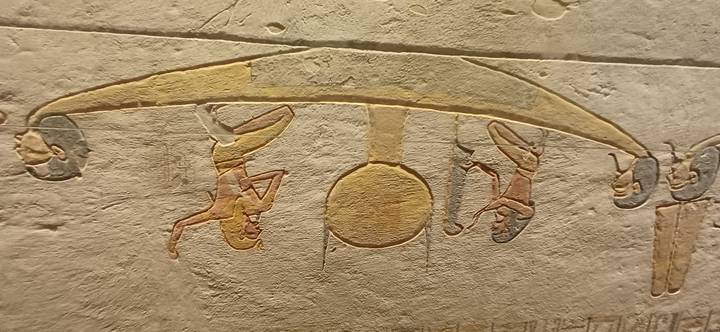 Hieroglyphic scene of figures paddling the solar bark with the sun disk at center