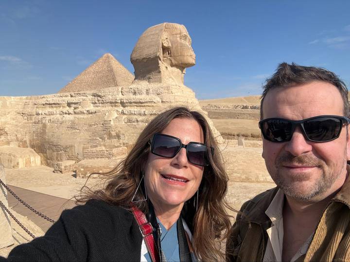 Selfie of couple in front of the Sphinx and Great Pyramid on a clear day.